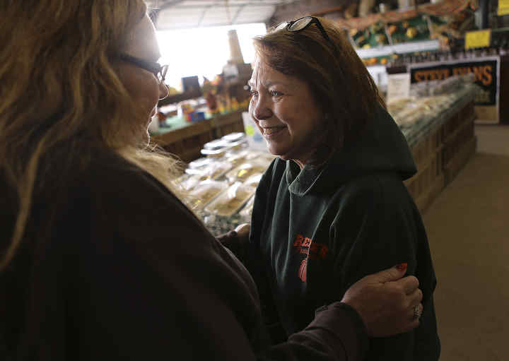 Linda Renick (right) gets a bit teary after hugging longtime customer and former employee Carla Draise of Ashville at Renick's Family Market. "People keep saying, 'We heard a rumor. Is it true?'" Linda said. "And then sometimes when we tell them it is, they cry."  (Jonathan Quilter / Photo by Jonathan Quilter)